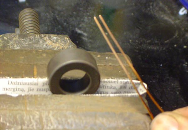 Core in a vise, two copper wires with laquer stripped at the ends