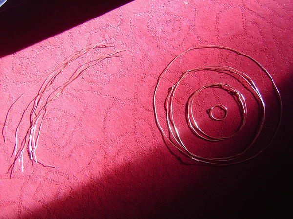 Copper wires without insulation, some bent into circles